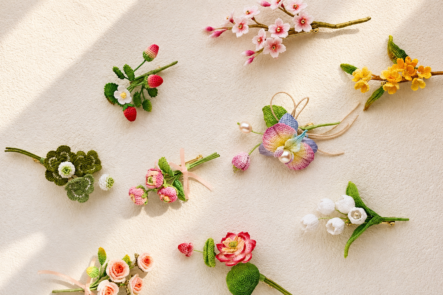 MIMO micro crochet flowers, strawberries and miniature botanical pieces arranged on a soft cream background