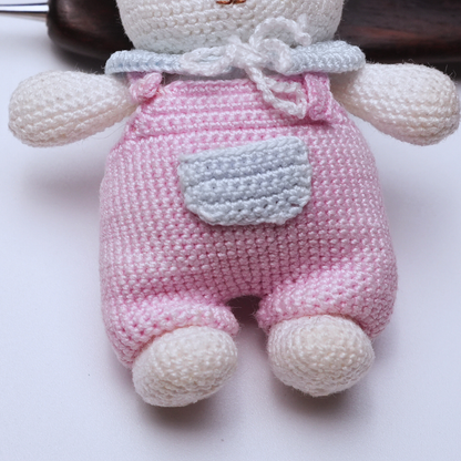 Close-up detail of handmade micro crochet bear charm showing fine stitching and miniature craftsmanship.
