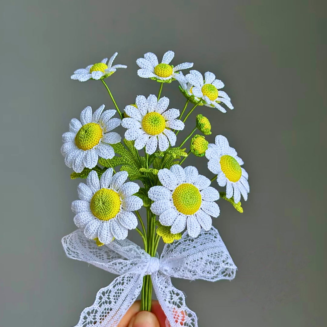 Hand holding bouquet style crochet chamomile daisy earrings, micro crochet floral detail