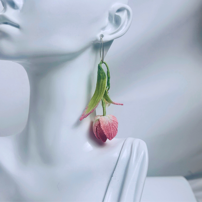 micro crochet tulip earrings worn on ear, long floral dangle style