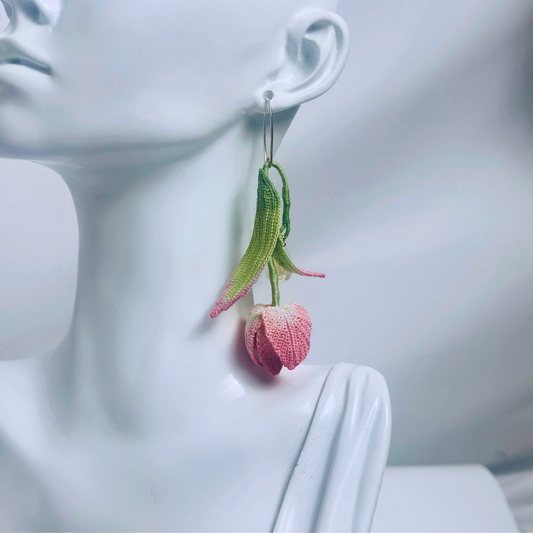 micro crochet tulip earrings worn on ear, long floral dangle style
