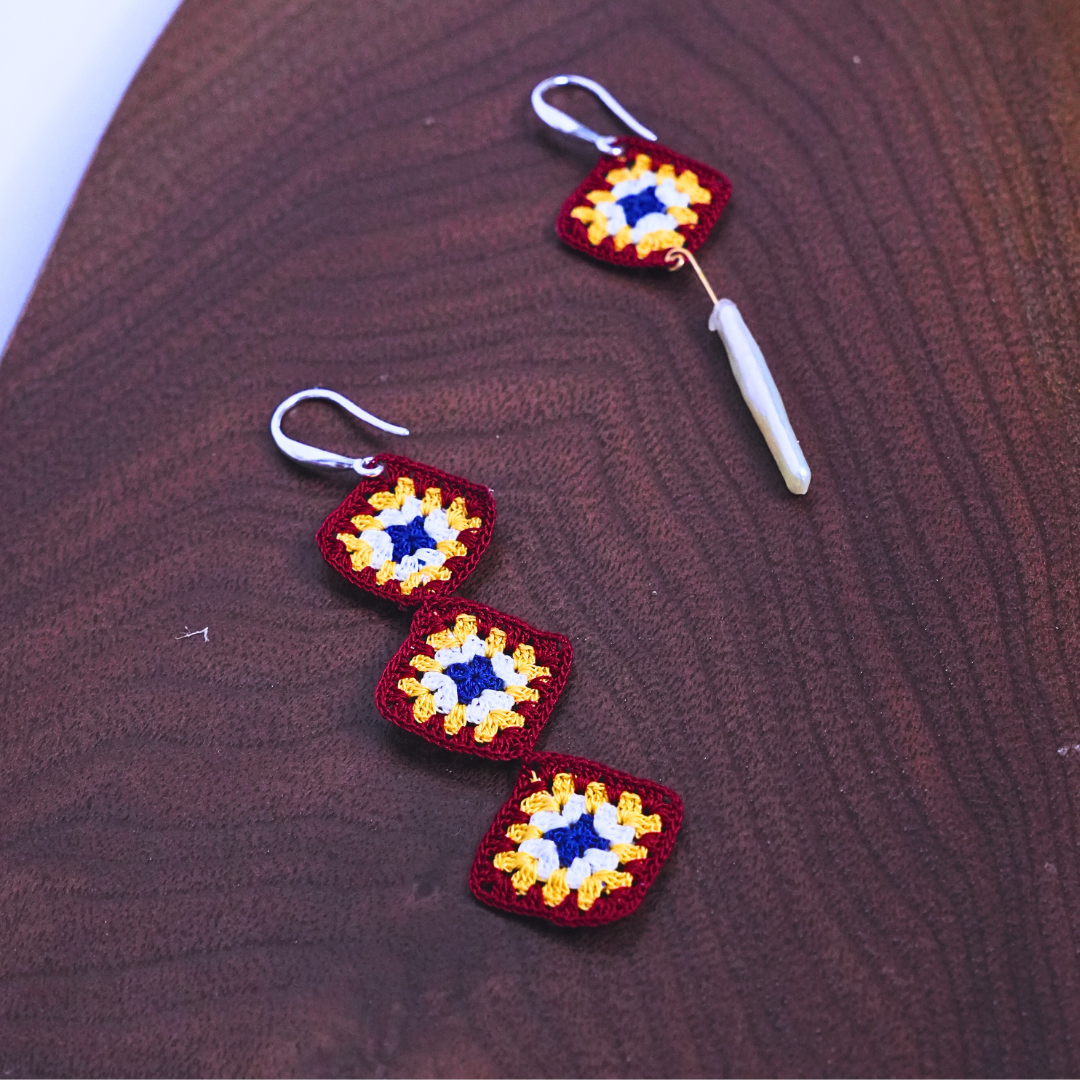 Asymmetrical granny square crochet earrings showing square and pearl drop design