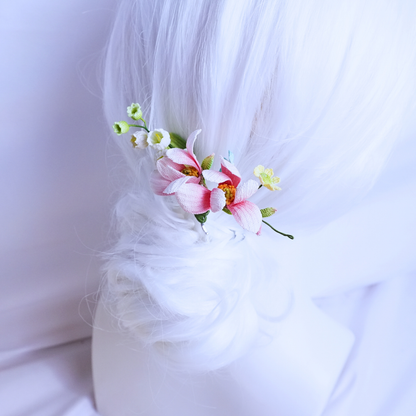 Micro crochet magnolia hair comb worn in a soft updo with pink flowers and delicate floral accents