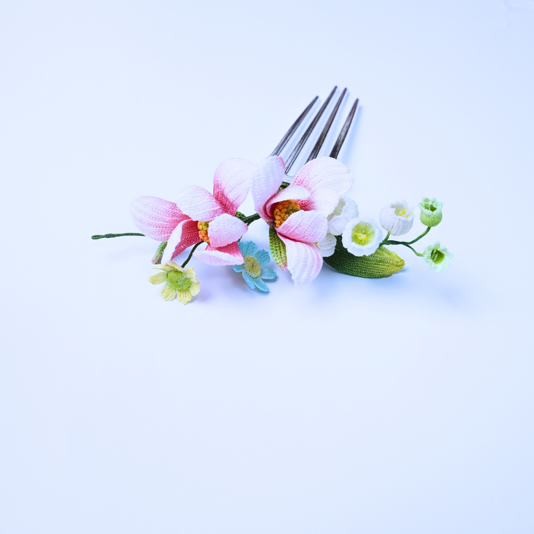 Side view of a handmade micro crochet magnolia hair comb with layered flowers and fine floral details