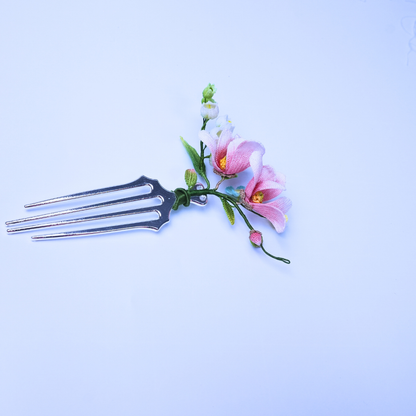 Micro crochet magnolia hair comb with pink flowers and small white blossoms on a metal comb base