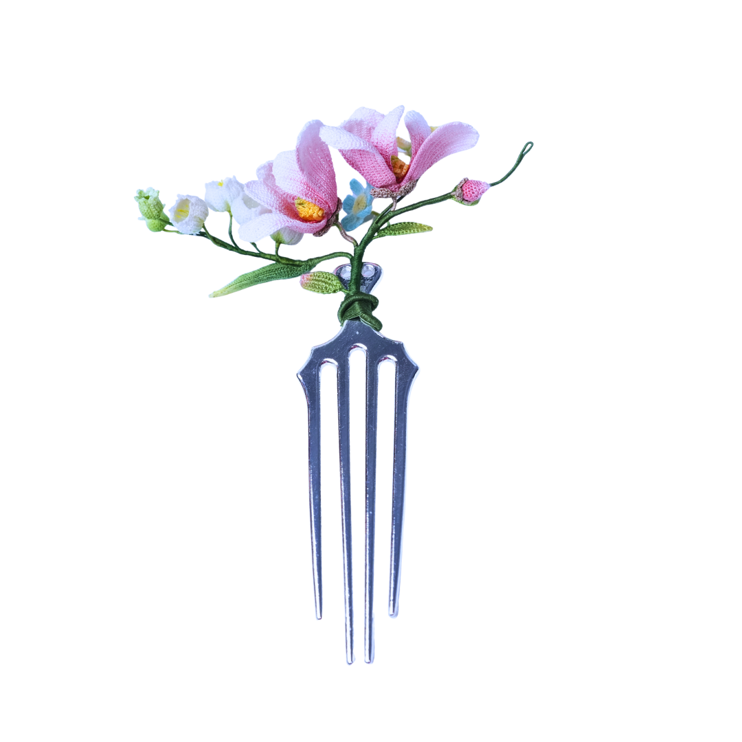Handmade micro crochet magnolia hair comb with pink and white flowers on a metal comb base