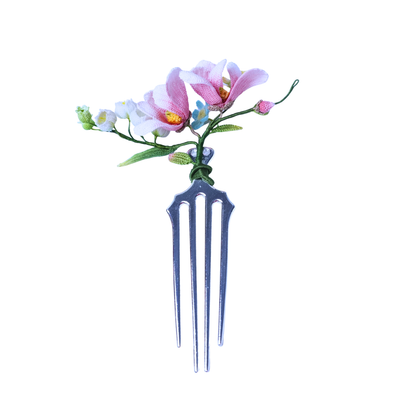 Handmade micro crochet magnolia hair comb with pink and white flowers on a metal comb base