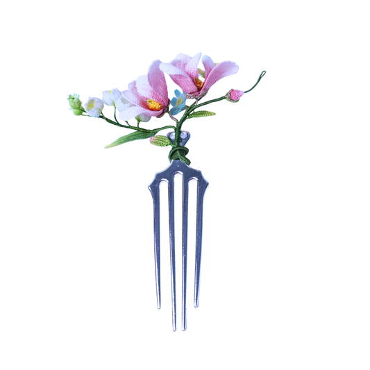 Handmade micro crochet magnolia hair comb with pink and white flowers on a metal comb base