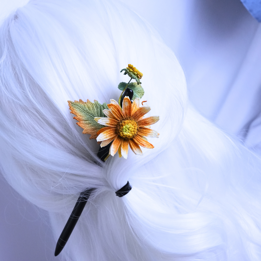 handmade crochet sunflower hair stick with ebony wood pin worn in bun hairstyle