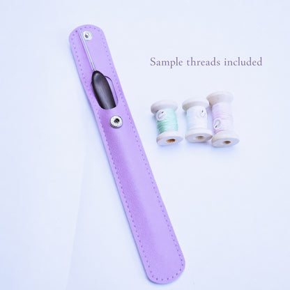 Micro crochet hook in a lavender storage sleeve with sample threads on a white background