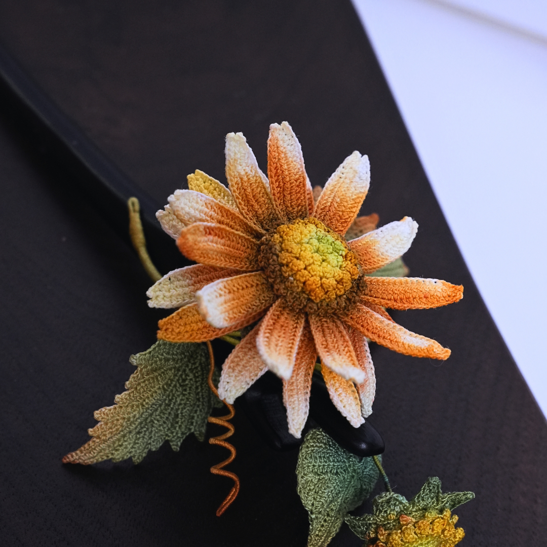 handmade crochet sunflower hair stick flat lay